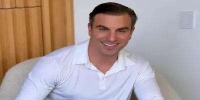 Brian Chesky, co-founder of Airbnb, smiling at the camera.