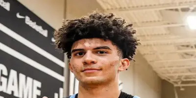 An image of Cameron Boozer flaunting his curly dark hair.