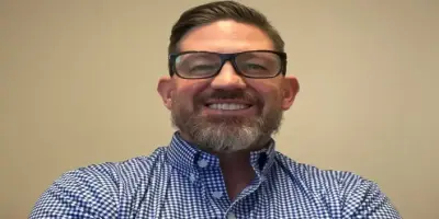 Peter Nottoli with a full beard and glasses.