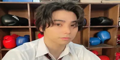 Nijirô Murakami in a white collared shirt and tie.