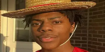 IShowSpeed wearing a straw hat with a red band