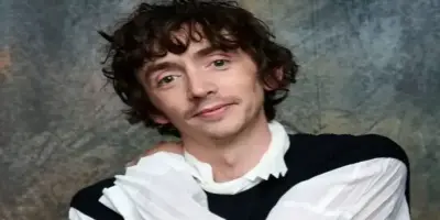 Samuel Blenkin with curly brown hair.