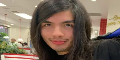 Eduardo Franco is smiling softly.