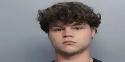 Jack Doherty with messy, dark curly hair, looking serious.