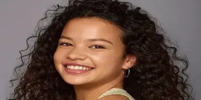 Catherine Laga’aia with long, curly dark hair