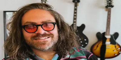 Close-up of singer Adam David with long hair.