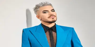 Adam Lambert, with spiked hair and  eye makeup,