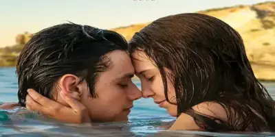 Louis Partridge and Millie Bobby Brown in water.